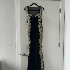 Elegant Black and Gold Prom Dress with Floral Details and Sheer Back